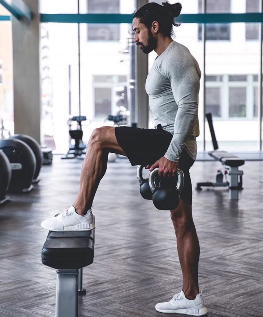 Justin Gonzales doing lunges on a bench lookin fit