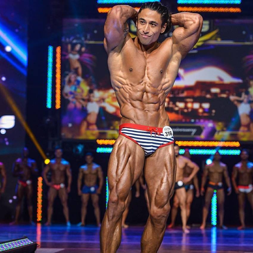 Justin Gonzales competing on the WBFF Fitness Model stage