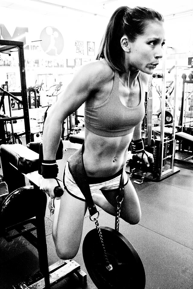 Kimberly Marie doing weighted dips in the gym.