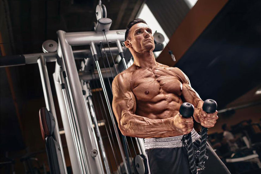 Kirk Miller performing a rope exercise in the gym.