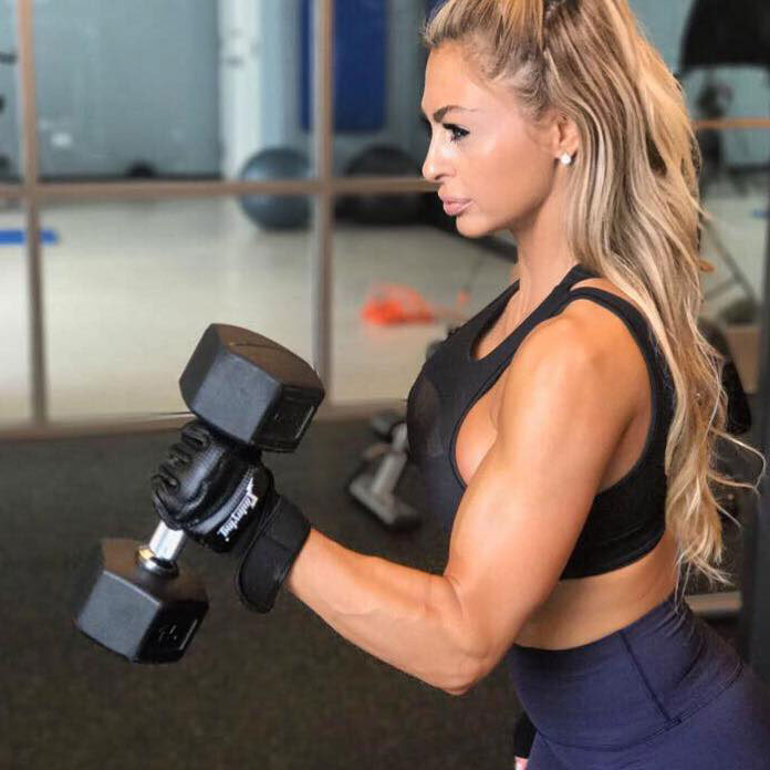 Laura Michelle Prestin working out with dumbbells.