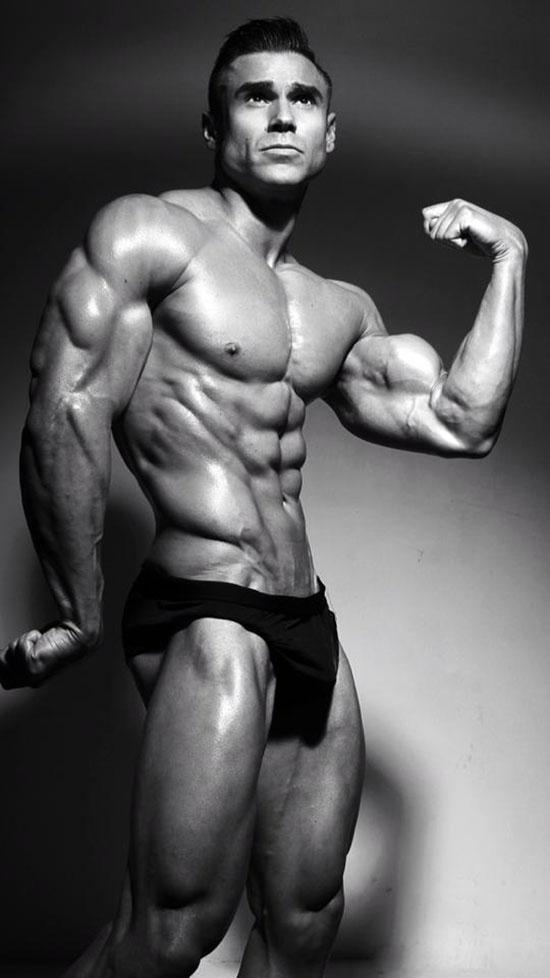 Matt Christianer flexing his bicep in a photo shoot.