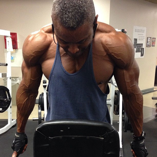 Michael Anderson performing tricep dips in the gym.