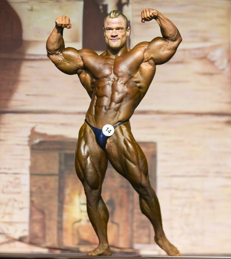 Nicolas Vullioud doing a front double biceps pose on the bodybuilding stage