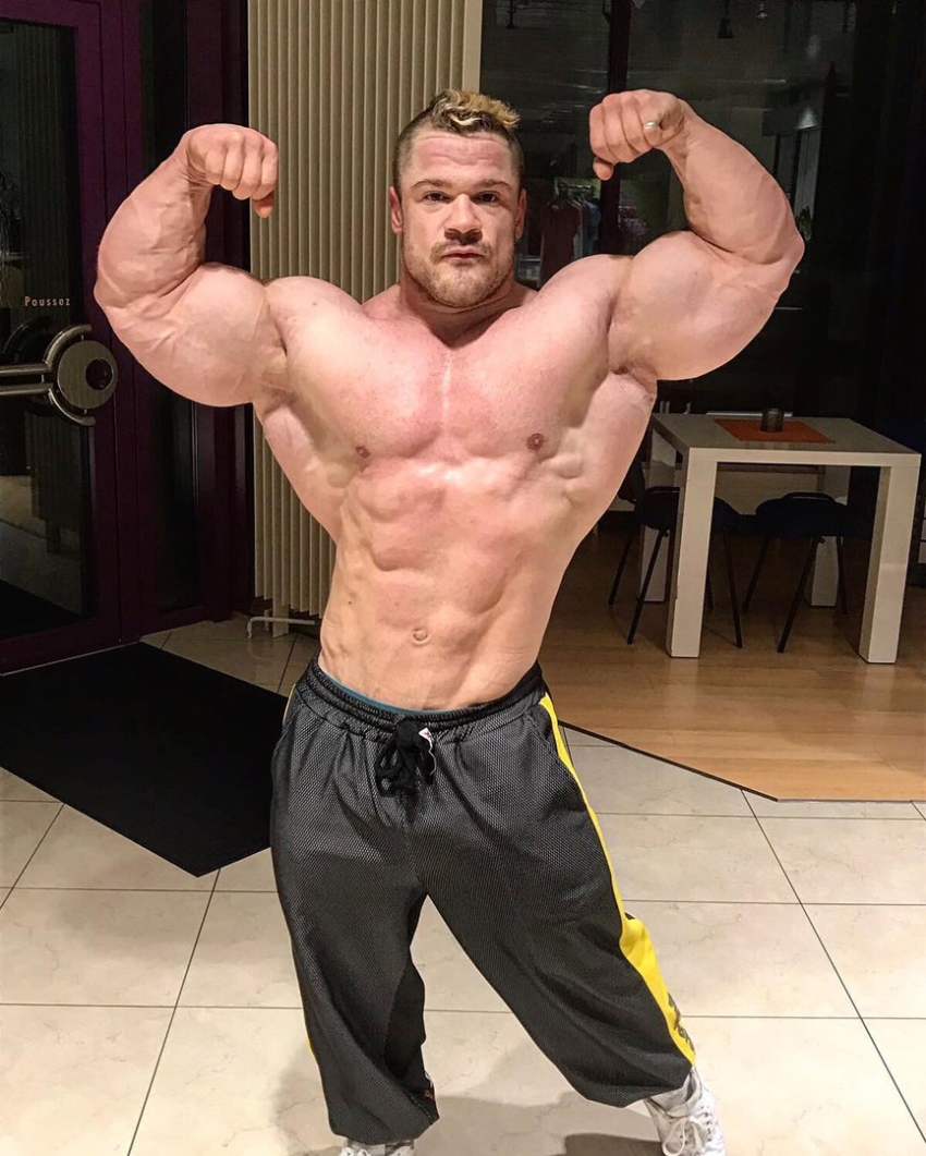 Nicolas Vullioud doing an off-season shirtless front double biceps flex