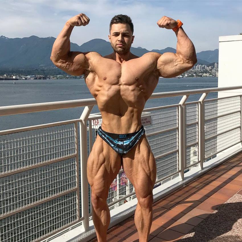 Regan Grimes shirtless outdoors flexing his biceps looking big and vascular