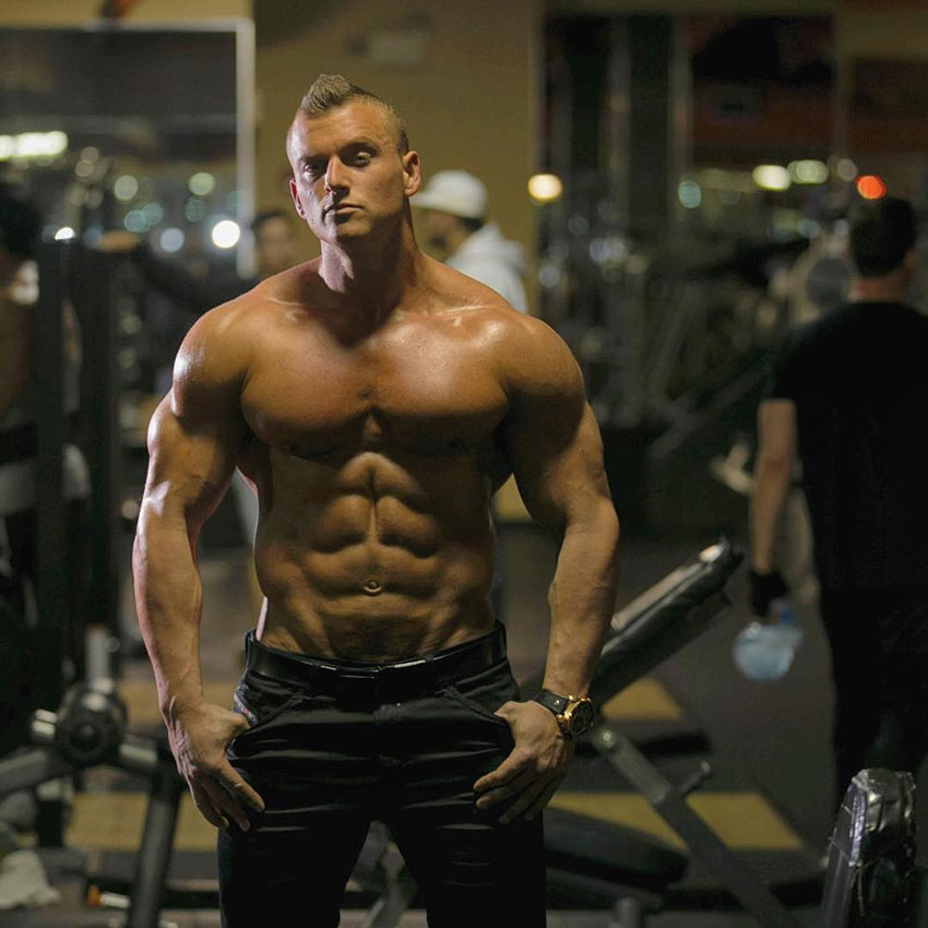 Samuel Dixon posing in the gym in a photo shoot.