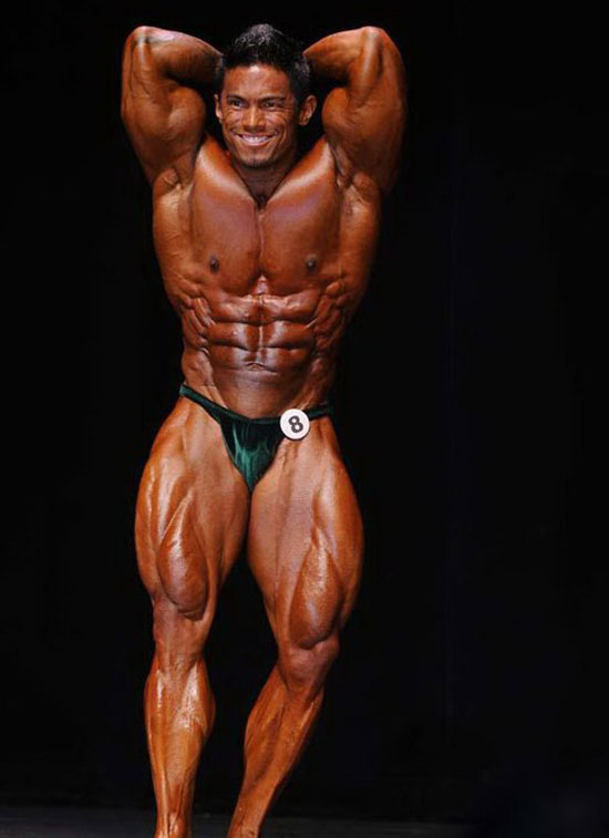 Stan McQuay posing on the bodybuilding stage.