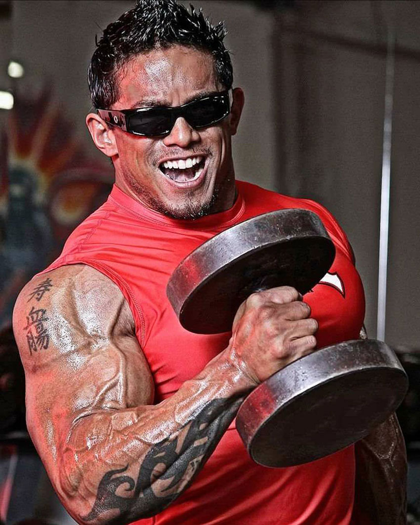 Stan McQuay performing dumbbell hammer curls.