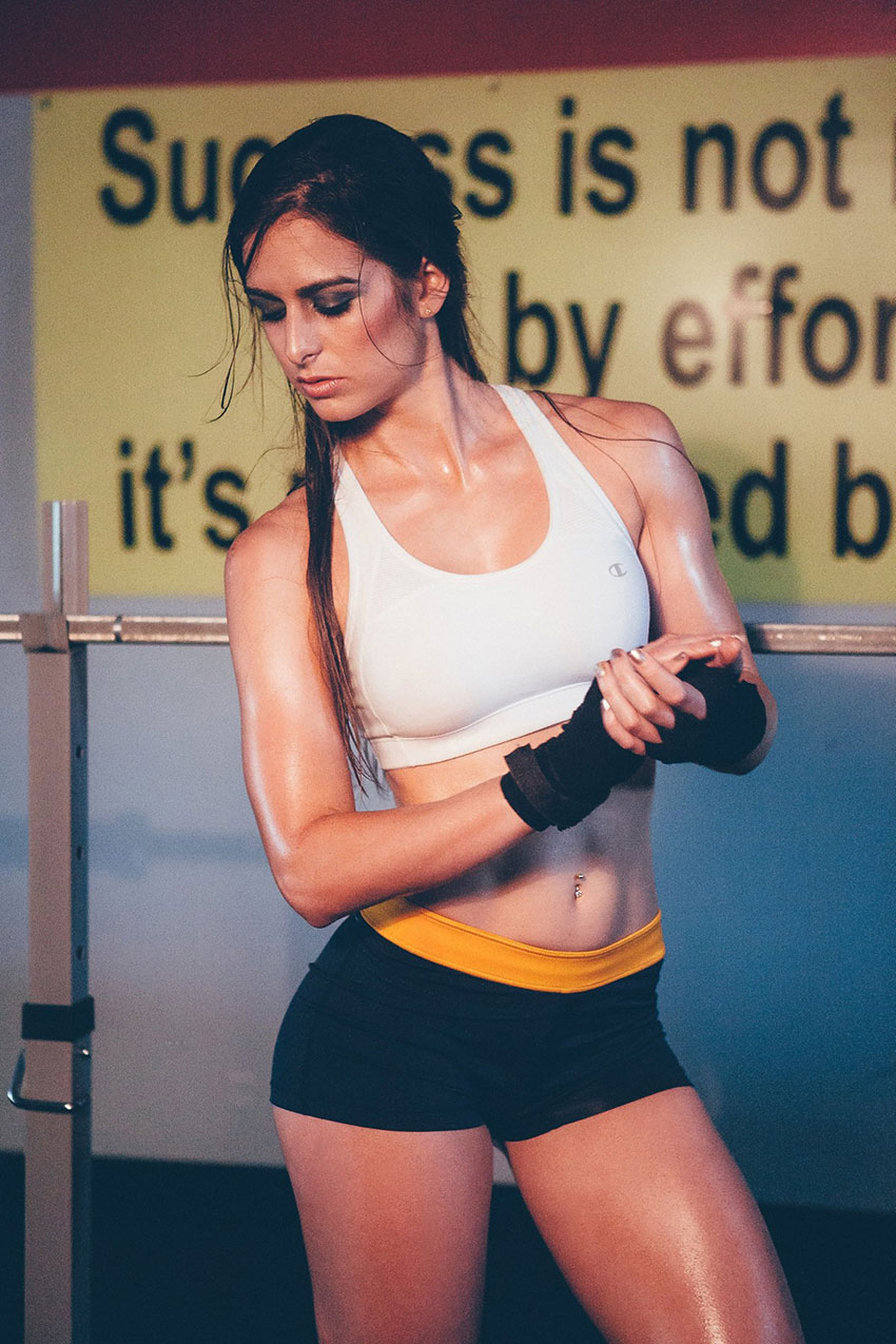 Stephanie Sequeira posing in a photo shoot wearing gloves.