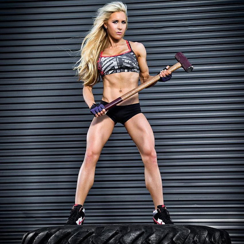 Anna McManamey holding a sledgehammer in the gym.