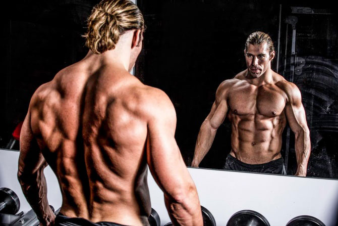 Craig Capurso looking into the mirror in a photo shoot.