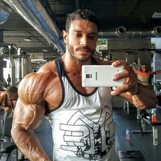 Hany Saeed taking a selfie of his ripped arms and shoulders
