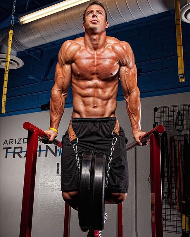 Jeremy Scott performing weighted pull-ups.