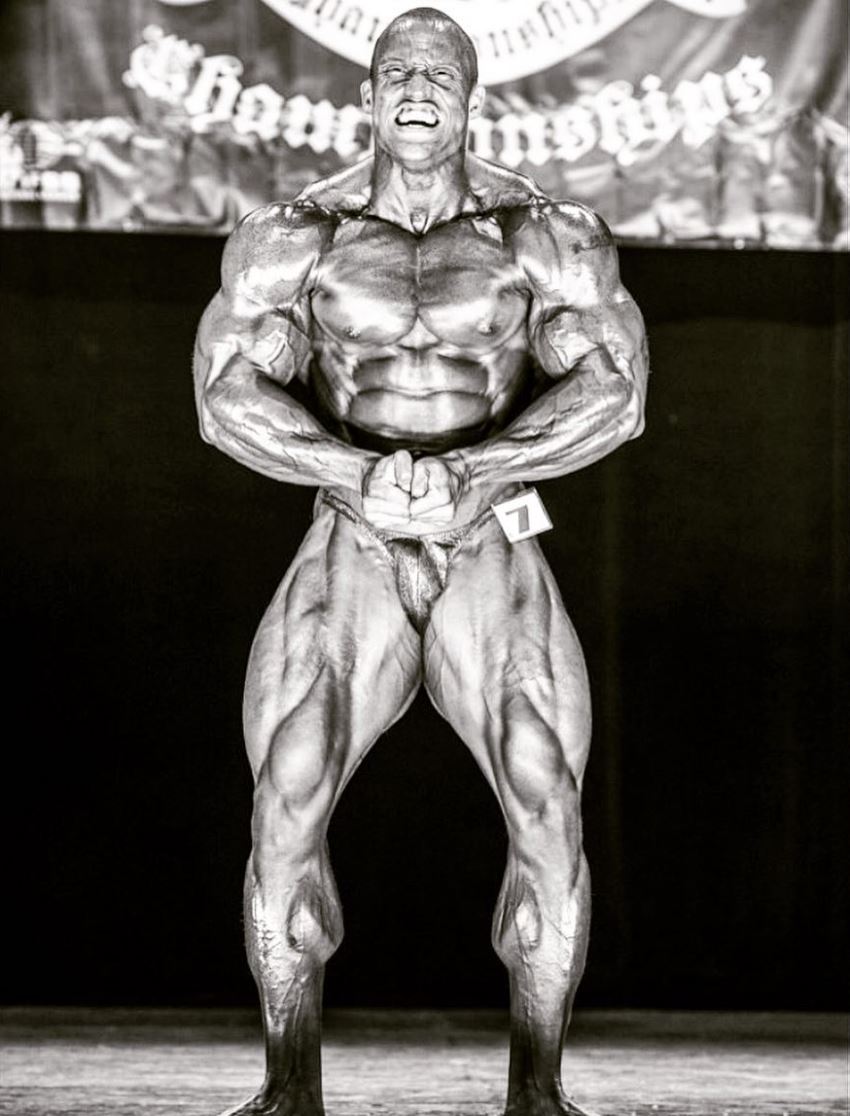 Kevin Jordan posing on the bodybuilding stage looking muscular and ripped