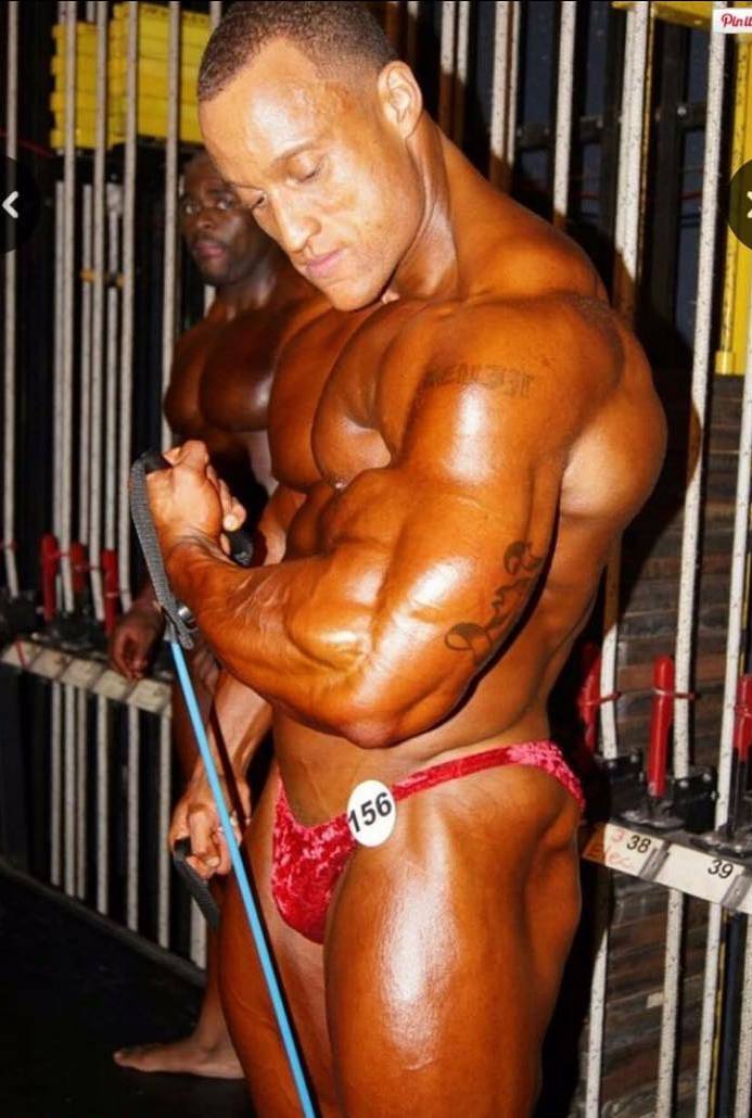 Kevin Jordan pumping up his muscles backstage before a bodybuilding contest