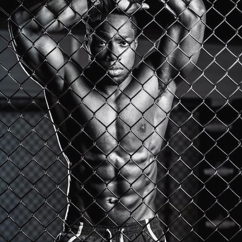 Kizzito Ejam showing off his lean physique in a martial arts cage.