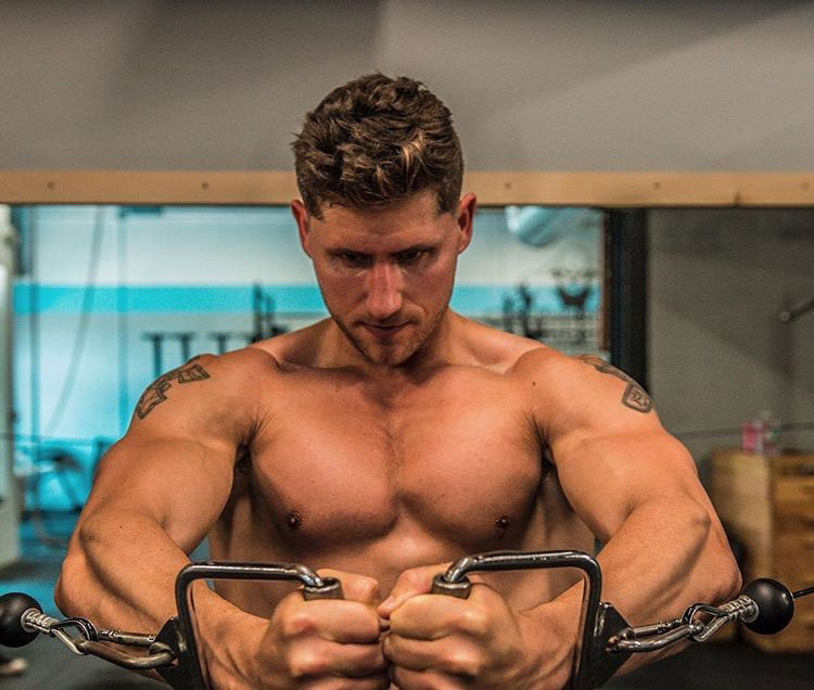 Matty Fusaro exercising in the gym with cables.