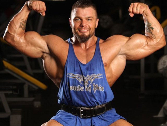 Mike Johnson flexing his biceps in a photo shoot.