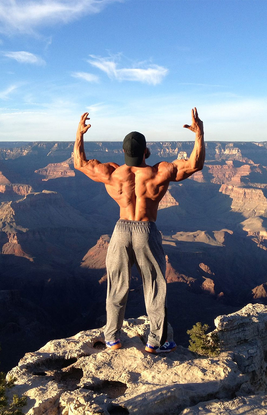 Mike Johnson stood next to a mountain ridge.