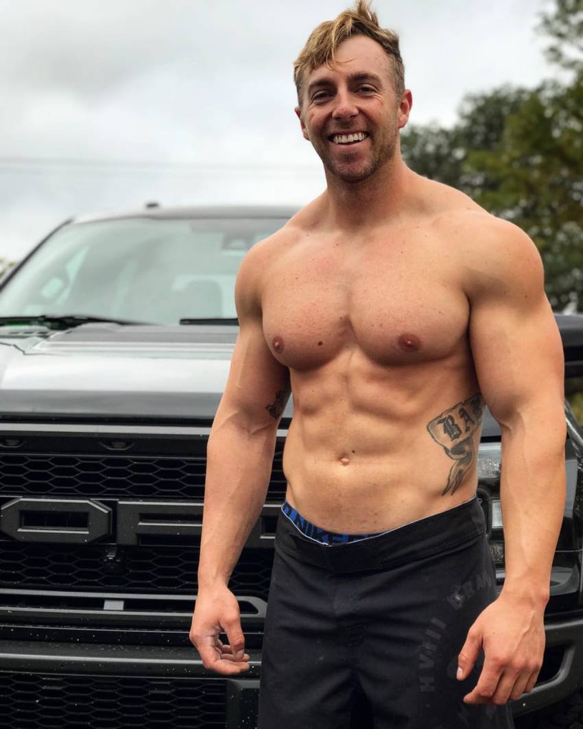 Nick Bare smiling shirtless for a photo, looking fit