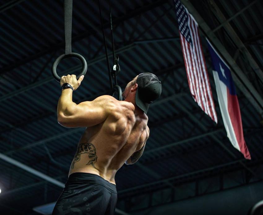 Nick Bare doing pull ups shirtless, looking ripped