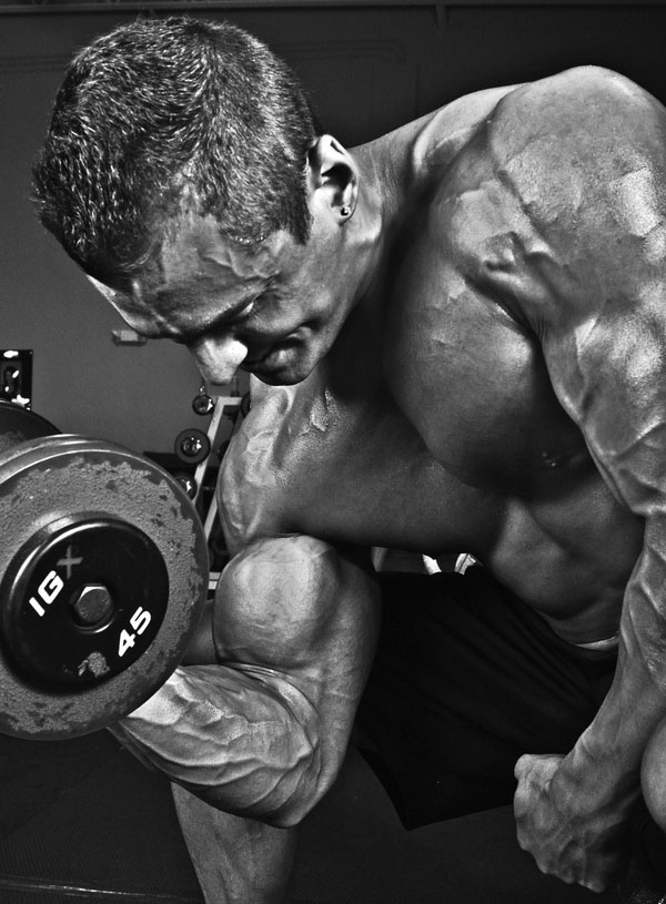 Ryan Hughes performing a dumbbell concentration curl.