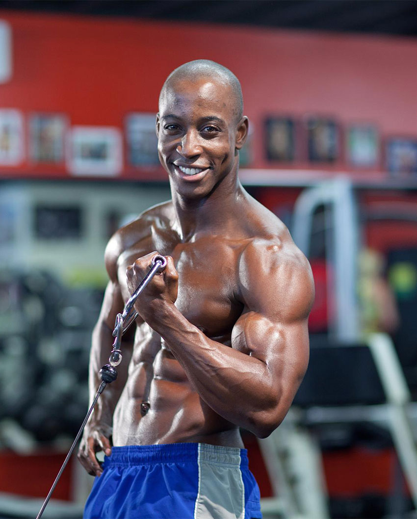 Shaka Smith exercising in the gym with a cable.