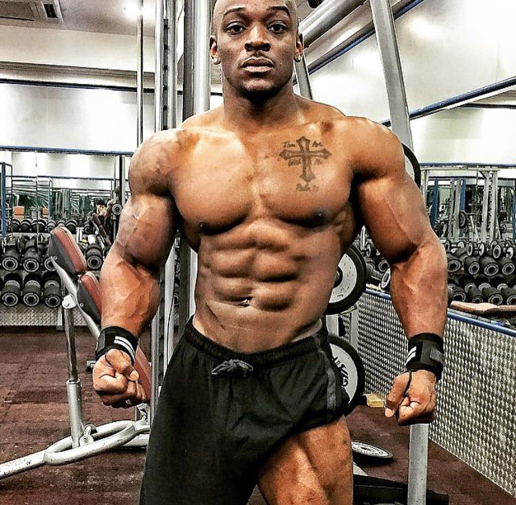 Tyrone Ogedegbe showing off his shredded physique in the gym.