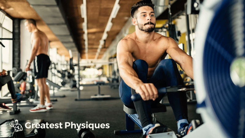 Hispanic athlete on the rowing machine in a gym