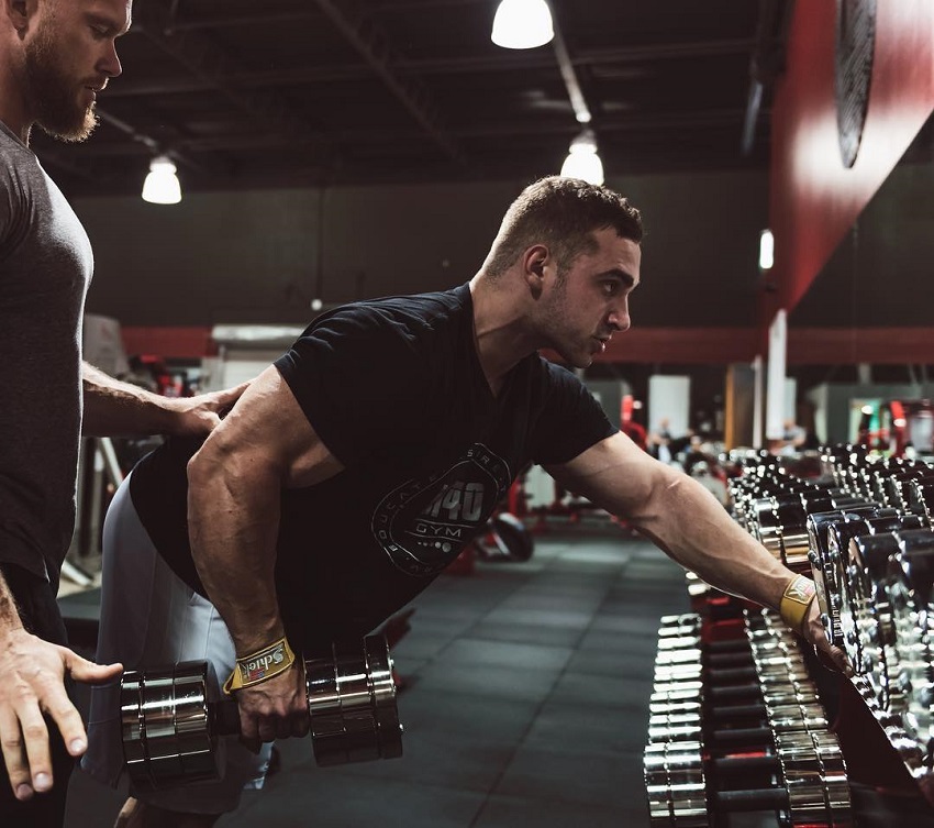 Cody Montgomery training his lats in a gym with Ben Pakulski