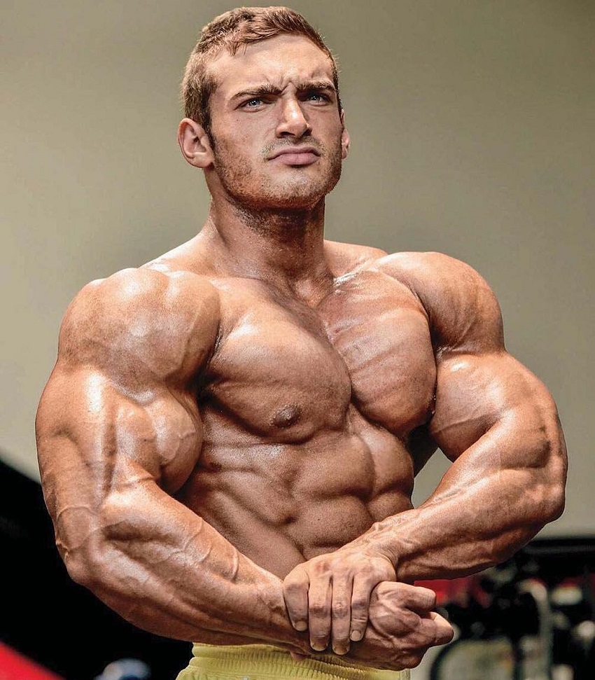 Cody Montgomery performing a side chest pose looking ripped and muscular