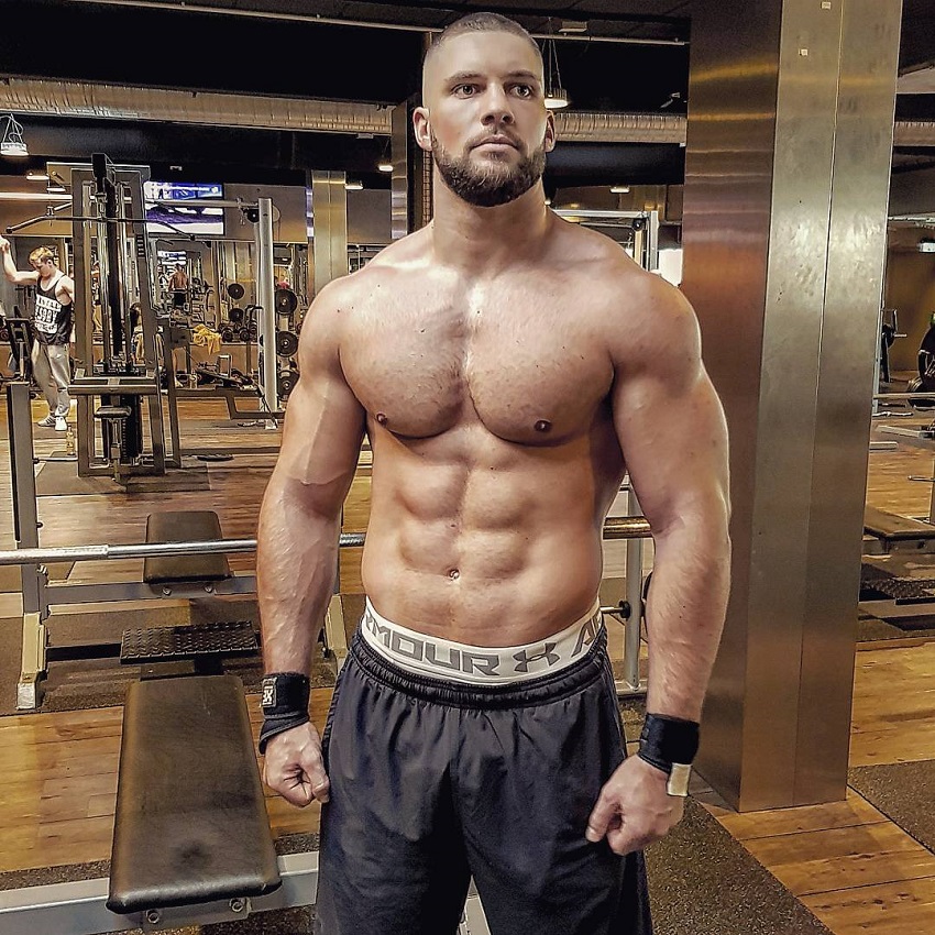 Florian Munteanu posing shirtless for a photo looking muscular and lean