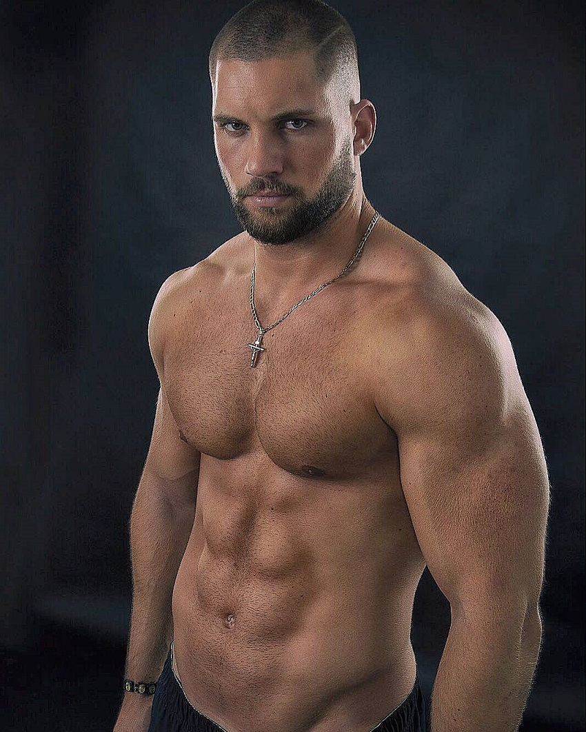 Florian Munteanu posing shirtless for a photo looking fit and muscular