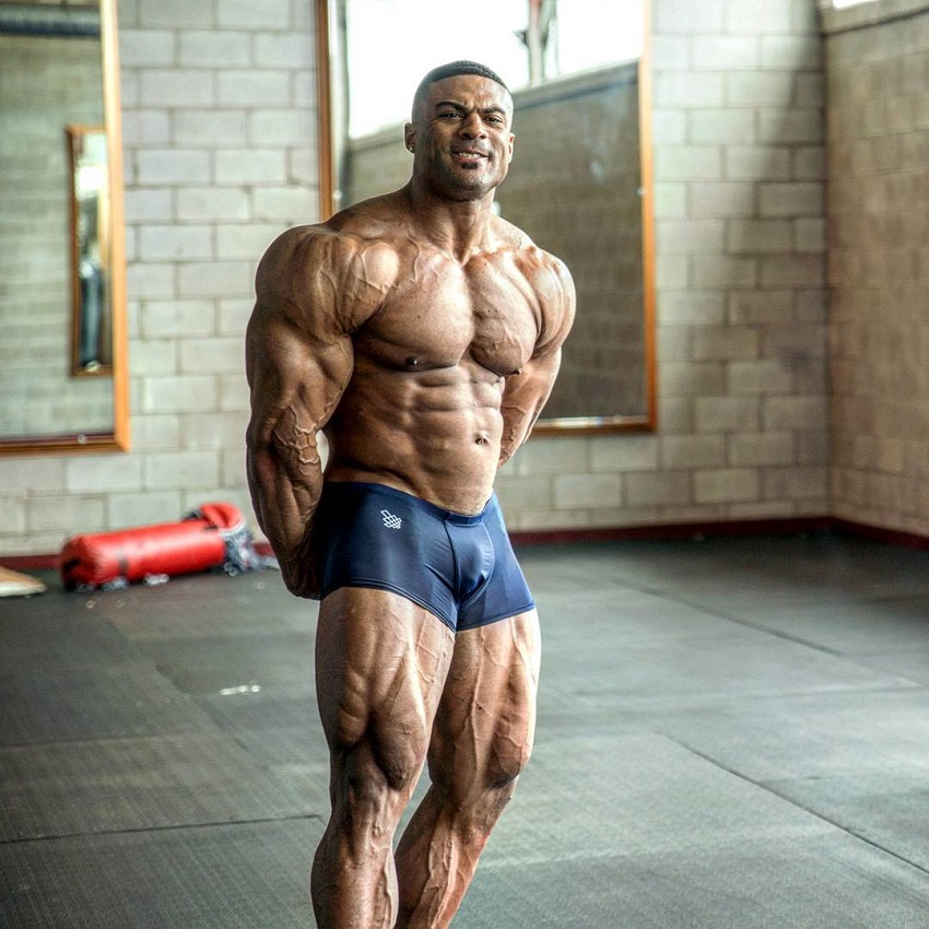 Henri-Pierre Ano posing shirtless, looking ripped and big