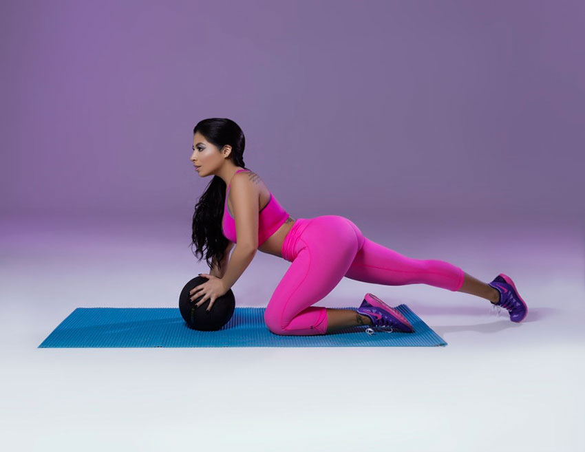 Jessenia Vice exercising with a medicine ball.