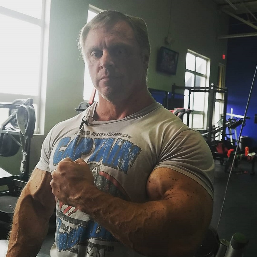 John Meadows showcasing his huge shirt-popping arms