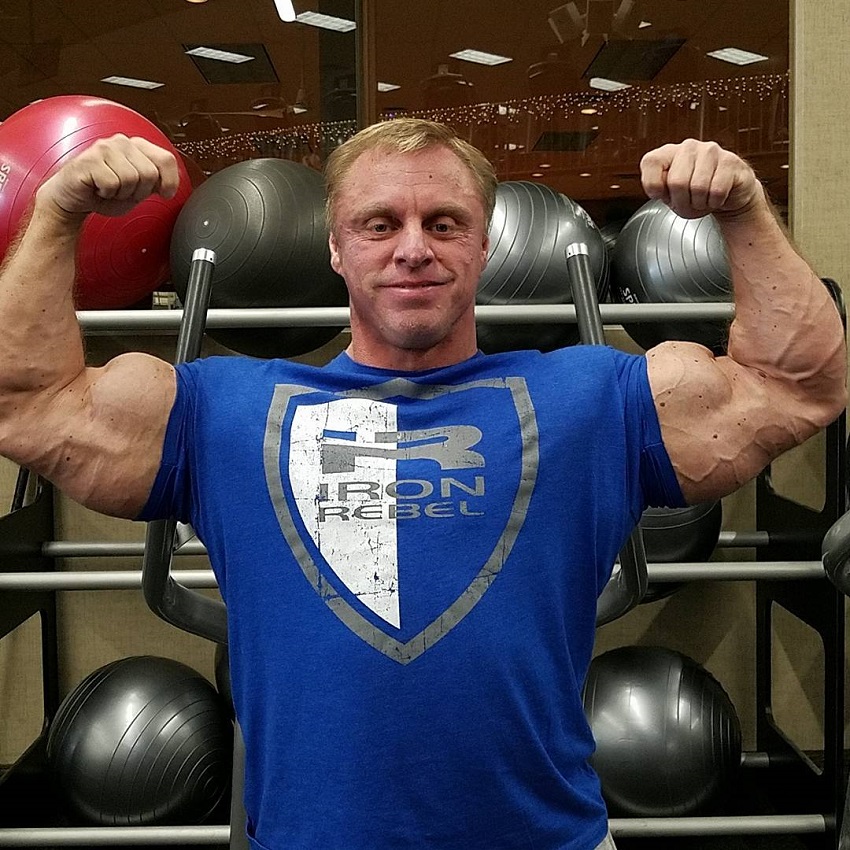 John Meadows flexing his biceps for a photo