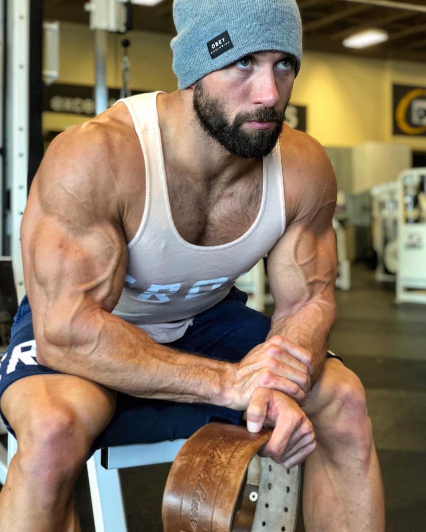 Julian Smith sitting on a bench looking big and vascular