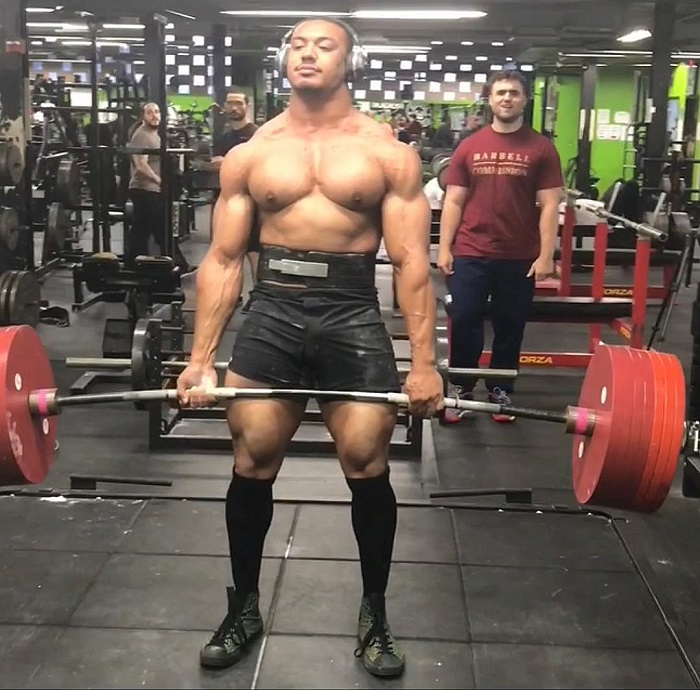 Larry Wheels lifting heavy deadlifts shirtless in the gym