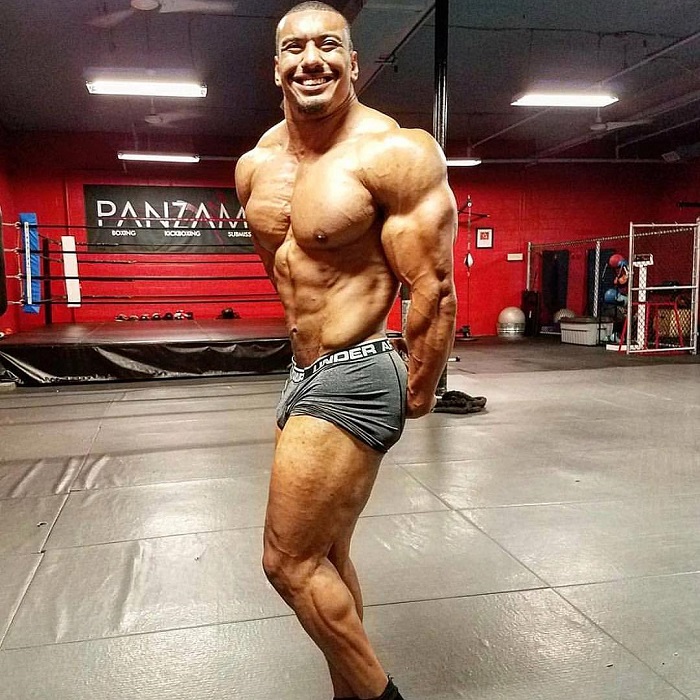 Larry Wheels doing a side triceps pose looking ripped