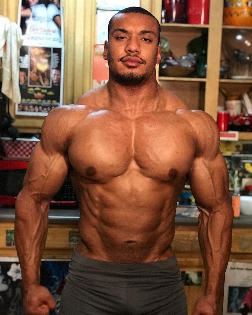 Larry Wheels posing shirtless for a photo looking big and strong