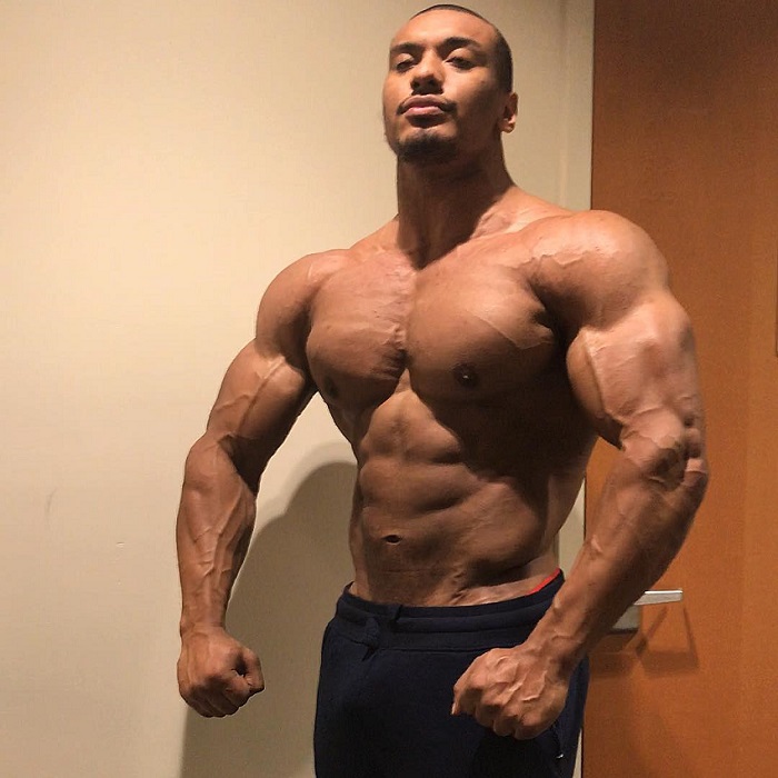 Larry Wheels posing shirtless showing off his ripped physique