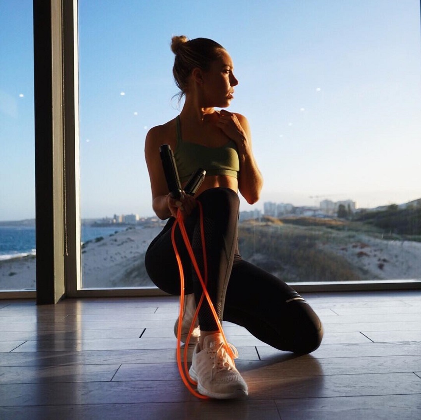 Sarah Day crouching wearing a sports wear looking fit and lean