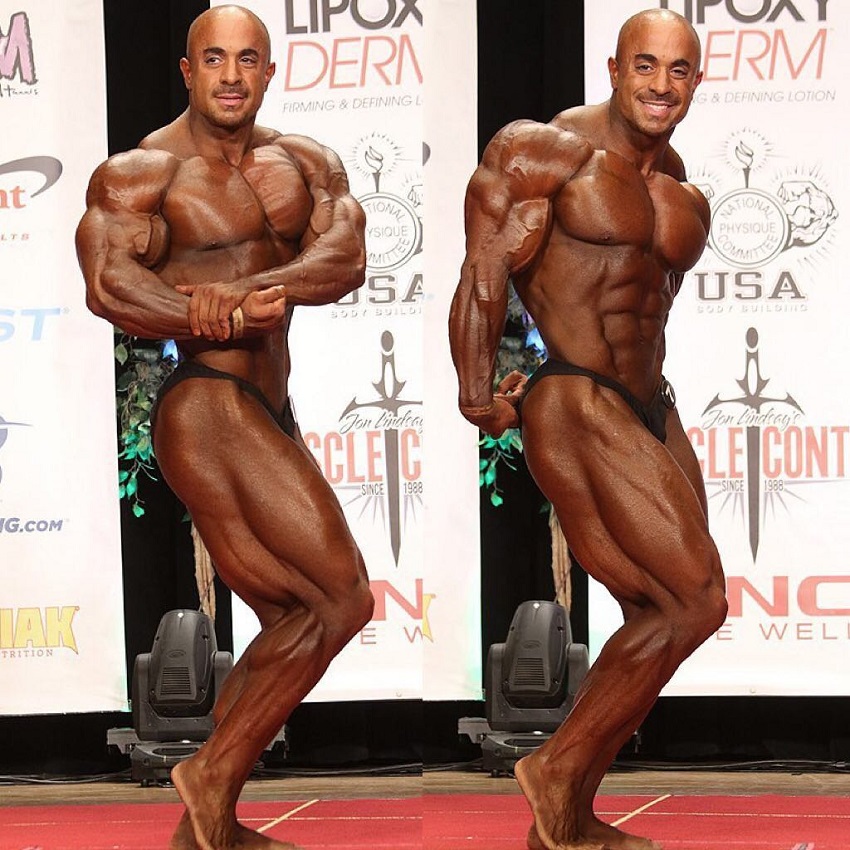 Sasan Heirati doing a side chest and side triceps pose on a bodybuilding stage