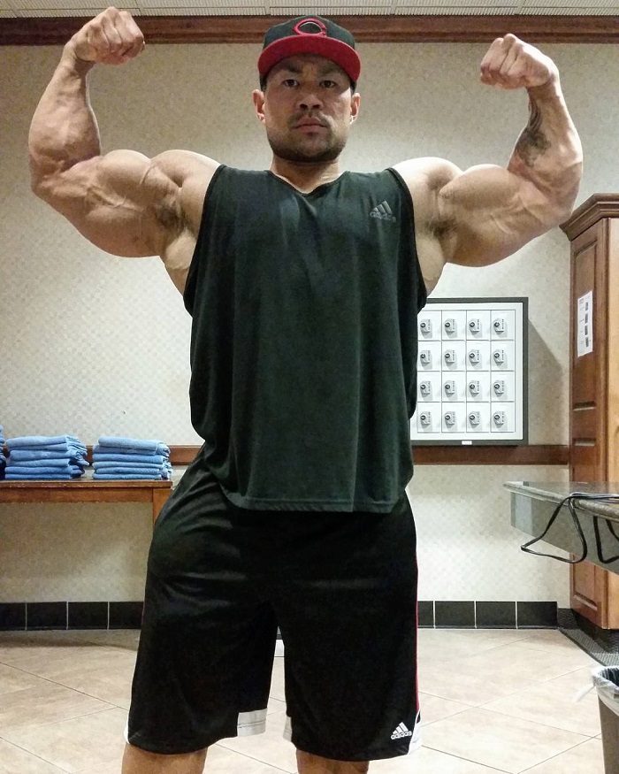 An Nguyen doing a front double biceps flex for a photo