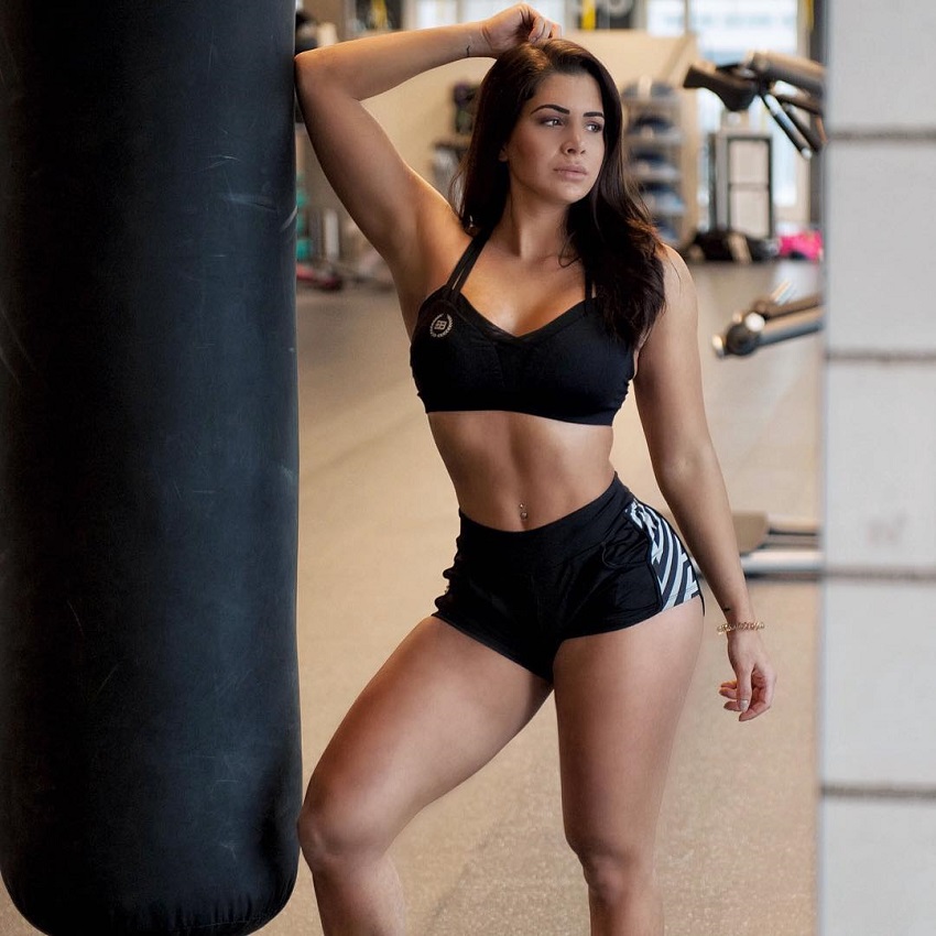 Andrina Santoro posing by the boxing bag wearing sports clothes looking fit