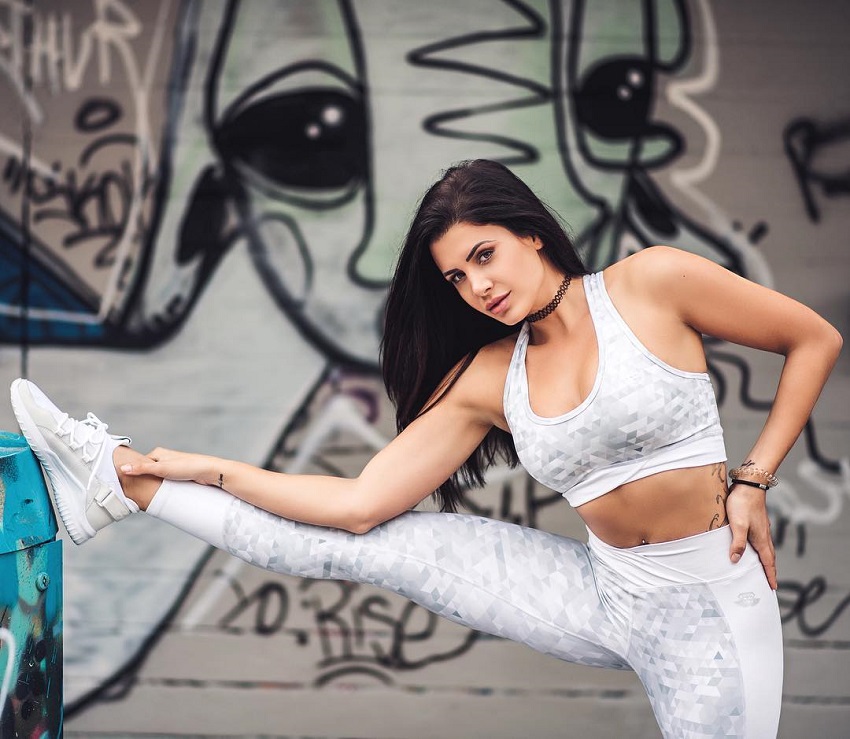 Andrina Santoro stretching her legs in white leggings looking healthy and fit