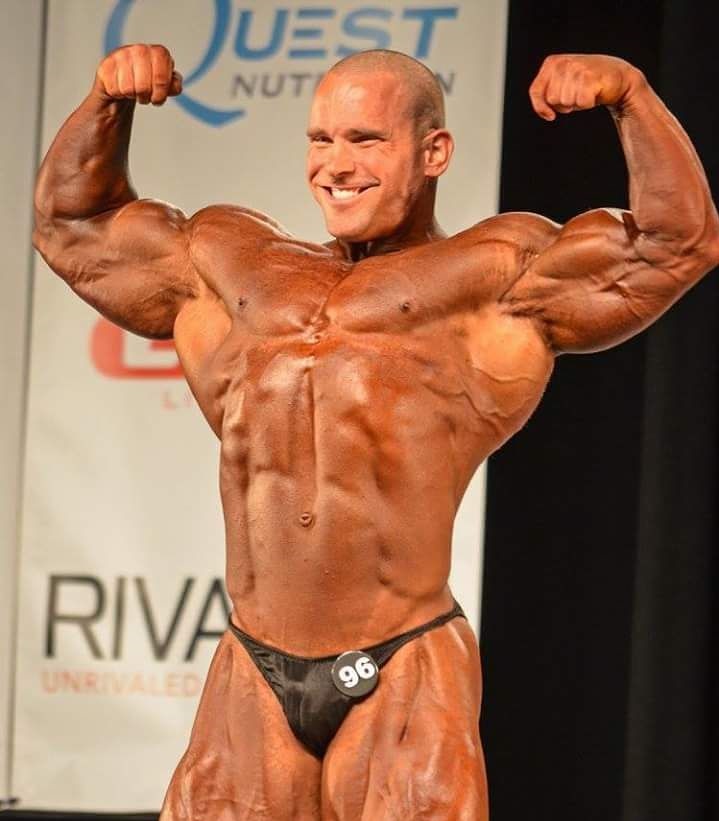 Jordan Janowitz doing a front double biceps pose looking big and muscular