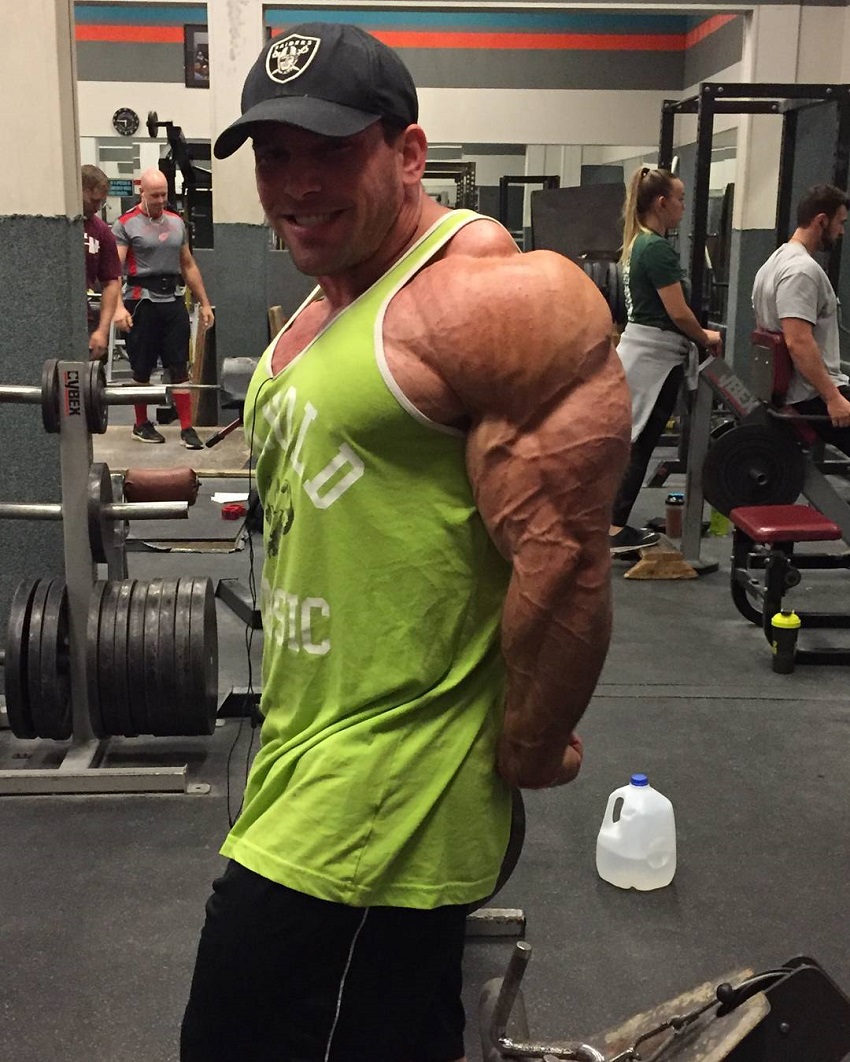 Jordan Janowitz flexing his triceps looking big and muscular